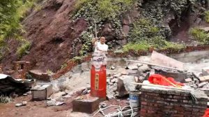Un oficial de cumplimiento de gestión urbana rompe una estatua de Buda con un martillo