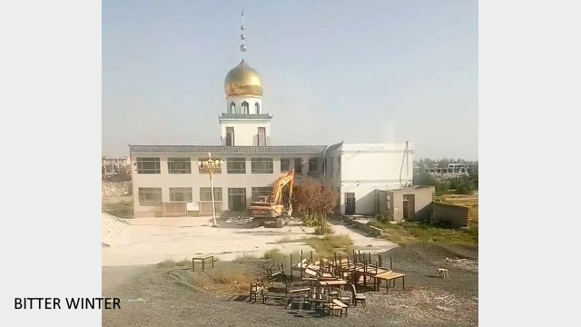 Excavadora demoliendo parte del edificio de la mezquita