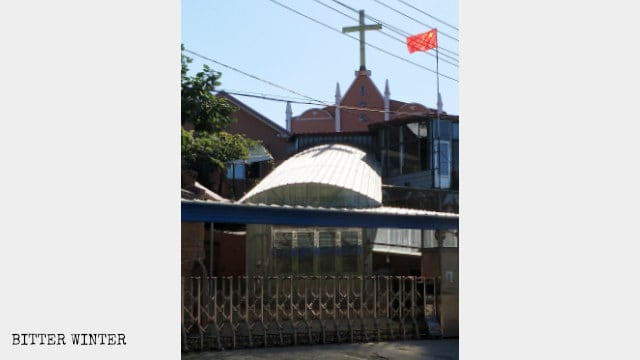 Bandera nacional ondeando en la iglesia cristiana del poblado de Jinshan