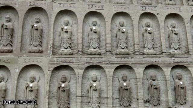 Foto de cerca de las estatuillas de Buda situadas en las paredes del acantilado.